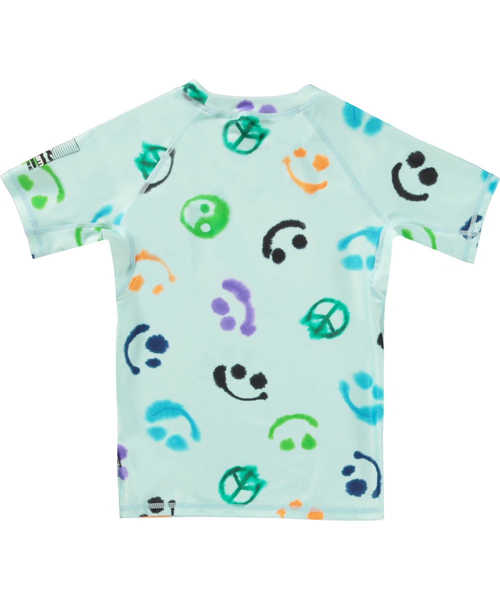 Neptune - Multi Smile - Classic rash guard in light blue with print of smiling faces, peace signs and yin/yang symbols 